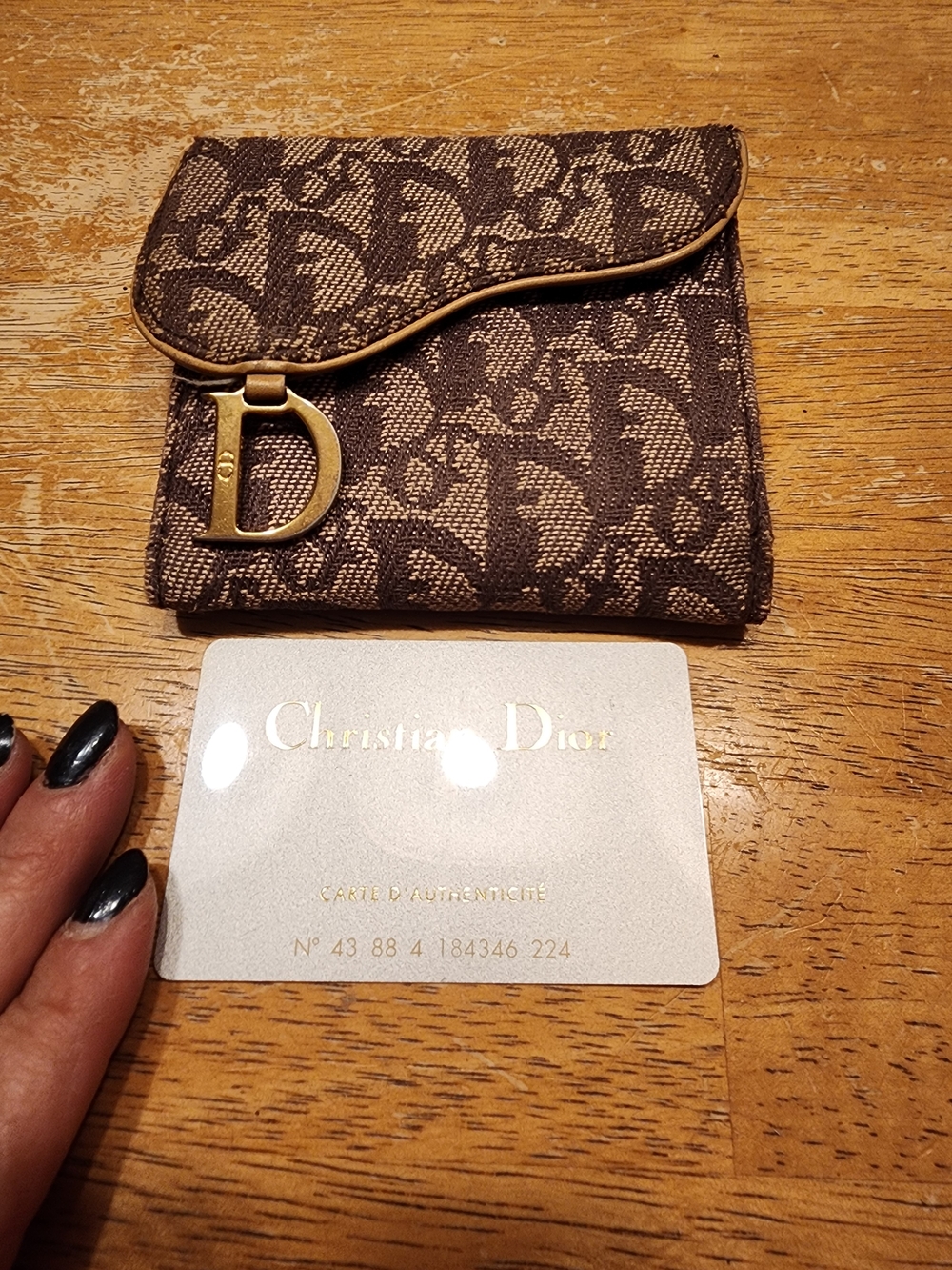 brown monogram Christian Dior Saddle Compact Wallet featuring the iconic Oblique